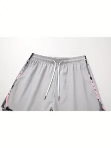 Dettaglio pantaloncini sportivi grigi da donna con coulisse e strisce laterali