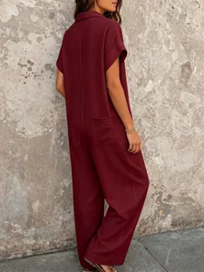 Back view of a casual burgundy short-sleeved wide-leg jumpsuit with collar and pockets