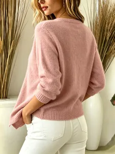 Detailed back view of a soft pink fuzzy knit sweater paired with stylish white jeans