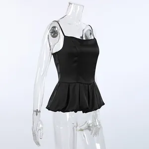 Close-up detail of a black satin sleeveless camisole top with elegant peplum hem