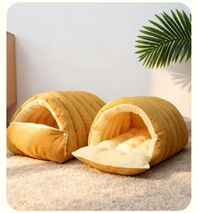 Detail showing mustard yellow corduroy exterior and soft plush interior of pet cave bed