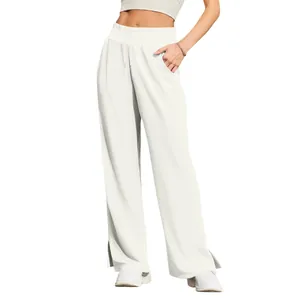 Detailed macro shot of white high-waisted wide-leg trousers featuring a stylish side slit
