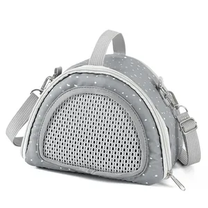 Detailed view of a grey polka dot small pet carrier bag featuring a breathable mesh window