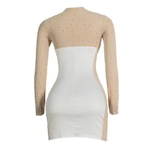 Detailed back view of a white bodycon mini dress with rhinestone-embellished mesh sleeves.