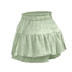 Close-up detail of women's summer ruffled skort in light green with smocked waist