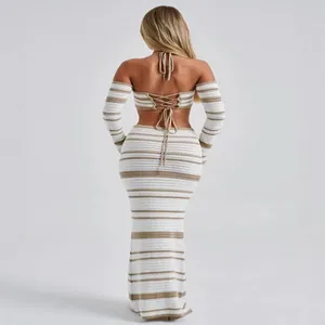 Back view of a chic striped crochet two-piece set with halter neck top and maxi skirt