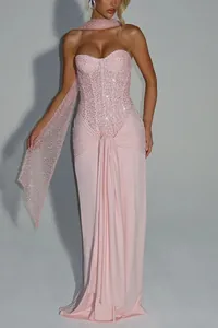 Detailed view of a sexy pink sequined strapless evening dress with elegant draped wrap