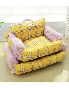 Detailed texture of thick bouclé fleece cat sofa with cute googly eye decor.