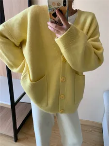 Detailed view of a lemon yellow oversized V-neck knitted cardigan with front pockets