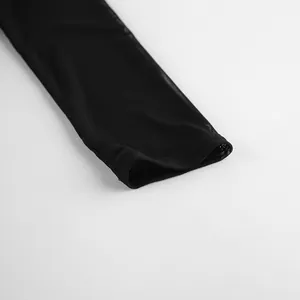 Detailed close-up showing the sleeve cuff and sheer mesh fabric of a black slim fit top