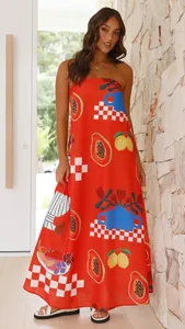 Vibrant red strapless maxi dress with tropical fruit and artistic prints on model