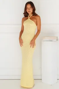 Elegant pale yellow halter-neck knitted maxi dress perfect for beach cover-up styling