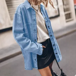 Women's retro loose light blue denim shirt with large pockets in an urban street style setting.