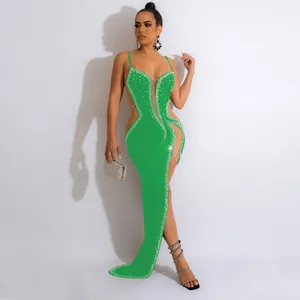 Detailed view of an elegant green evening gown with sparkling rhinestones and mesh inserts