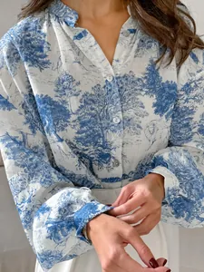 Elegant blue floral print blouse with mandarin collar and stylish lantern sleeves for spring