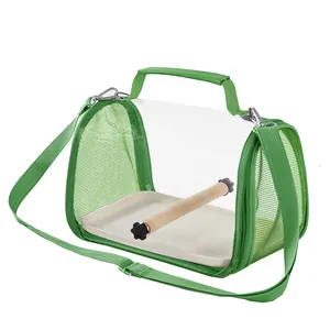 Detailed view of portable bird travel carrier featuring a wooden perch and clear window