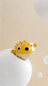 Detail view of yellow pufferfish dog chew toy with textured bumps