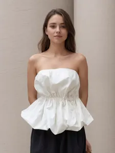 Elegant white strapless peplum top with a ruffled waist for a chic summer fashion look