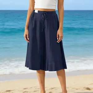 Comfortable navy blue wide leg culottes for women on a bright sunny beach background