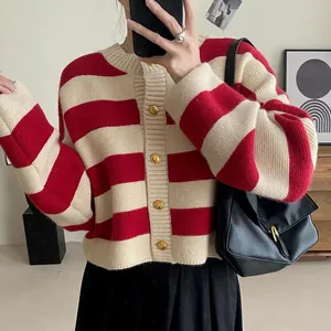 Close-up of a red and white striped knit cardigan with luxury gold buttons for women.