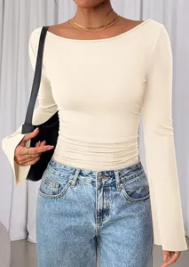 Detailopname van elegante crĆØme top met boothals, uitlopende mouwen en geplooide taille