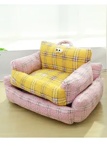 Detailed view of the thick boucle fleece texture and big eye decor on the cat sofa