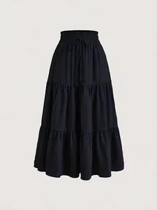 Detailed view of the textured fabric and elasticated waist on a black tiered maxi skirt
