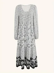 Detail shot of the various floral patterns and layered design on this long-sleeved maxi dress.