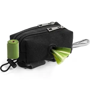Detail view of black dog waste bag dispenser with green roll bags and metal carabiner