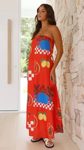 Full side profile of a red tube maxi dress featuring vibrant fruit and geometric prints.