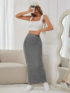 Full body view of a stylish gray ribbed knit high-waisted maxi skirt in a home setting
