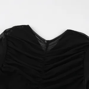 Close-up detail of the V-neckline and ruched mesh texture on this black slim-fit top.