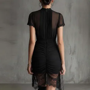 Back view of elegant black sheer lace patchwork mini dress with ruched details and slim fit