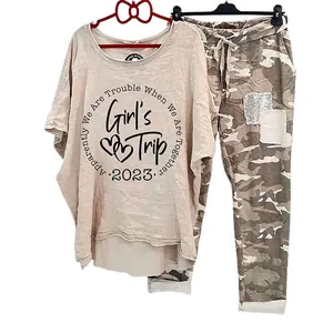 Close-up detail of women's camouflage joggers and printed oversized t-shirt set