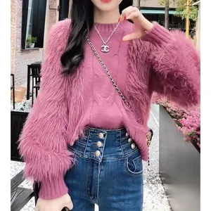 Detail view of a pink fuzzy cable-knit sweater with shaggy sleeves and soft texture for winter.