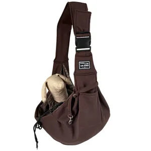 Brown breathable pet sling carrier with adjustable shoulder strap and secure buckle closure