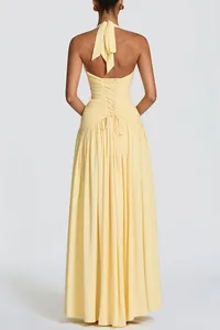 Elegant back view of a yellow halter neck maxi dress with corset lace-up detail and ruffles