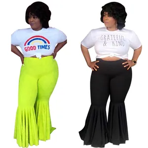 Detail of sexy high-waisted flare pants with pleated ruffle hem in neon green and black