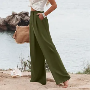 Pantaloni casual larghi a vita alta verde oliva da donna, indossati su una spiaggia