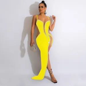 Detailed side view of a sexy yellow evening dress featuring rhinestones and mesh cutouts.