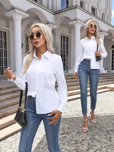 Classic white long-sleeved button-down shirt for women in a stylish casual outdoor setting