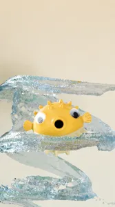 Close-up of pufferfish shaped pet toy being cleaned with dynamic water splashes