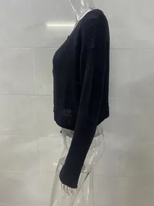 Detailed side profile of a women's black long-sleeved knit cardigan with buttons