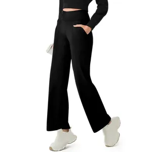 Detail of women's high-waisted black yoga pants with pockets and wide-leg design