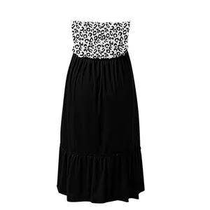 Detailed look at the leopard print smocked tube top and black ruffled maxi dress.