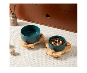 Dettaglio di ciotole in ceramica verde scuro per animali con supporti in legno di quercia