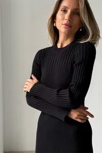 Detailed macro shot of a black ribbed knit long sleeve bodycon dress for winter