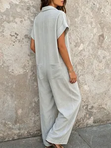 Back view of a loose short sleeve summer jumpsuit in a soft sage green fabric.