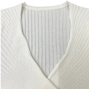Close-up of a white ribbed V-neck knit top showing the soft fabric texture