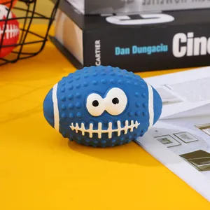 Blue latex squeaky rugby dog toy with funny cartoon face and nubby texture detail.